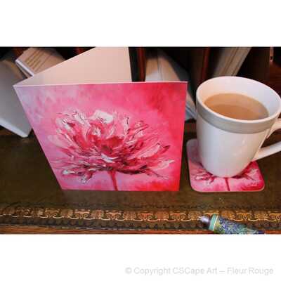 On the bureau are a greeting card, coaster and a cup of tea. The image is of the painting by CSCape entitled fleur rouge