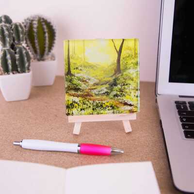 On a mini easel is a glass coater of 'Enter the glade of tranquillity'