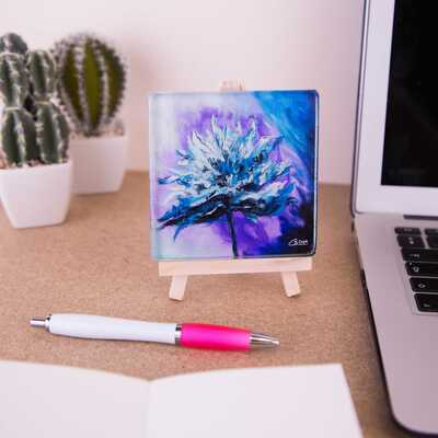 Glass coaster on a mini easel of a blue flower