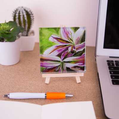 Mini easel holding a glass coaster of Lilies