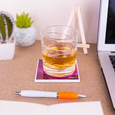 A whisky tumbler on top of the ceramic coaster of Moorland vale