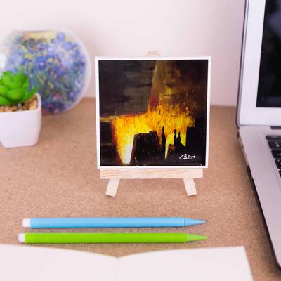 On a mini easel is a ceramic coaster of the painting Blast Furnace