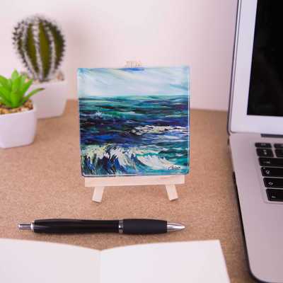 On a mini easel is a glass coaster of the painting Rhapsody in blue