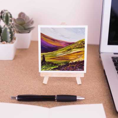 On a mini easel is a coaster of the painting The sentinel